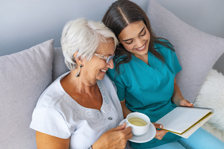 caregiver reading to woman