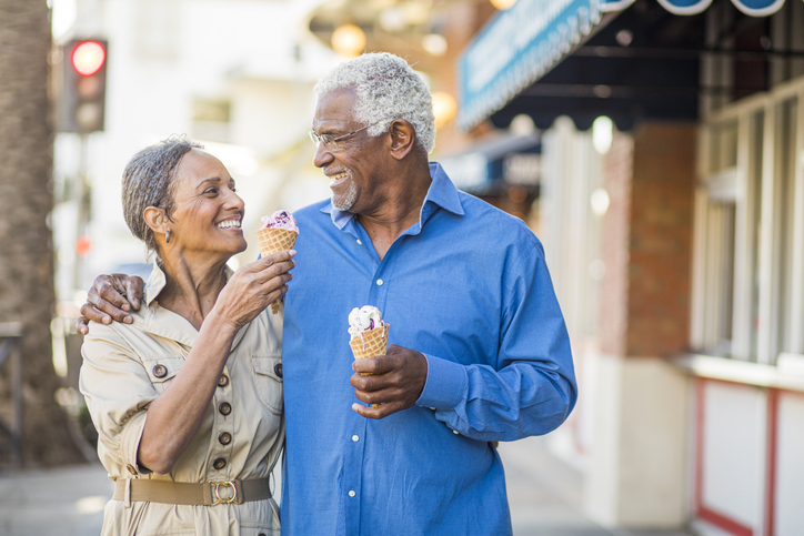 senior couple walking with ice cream