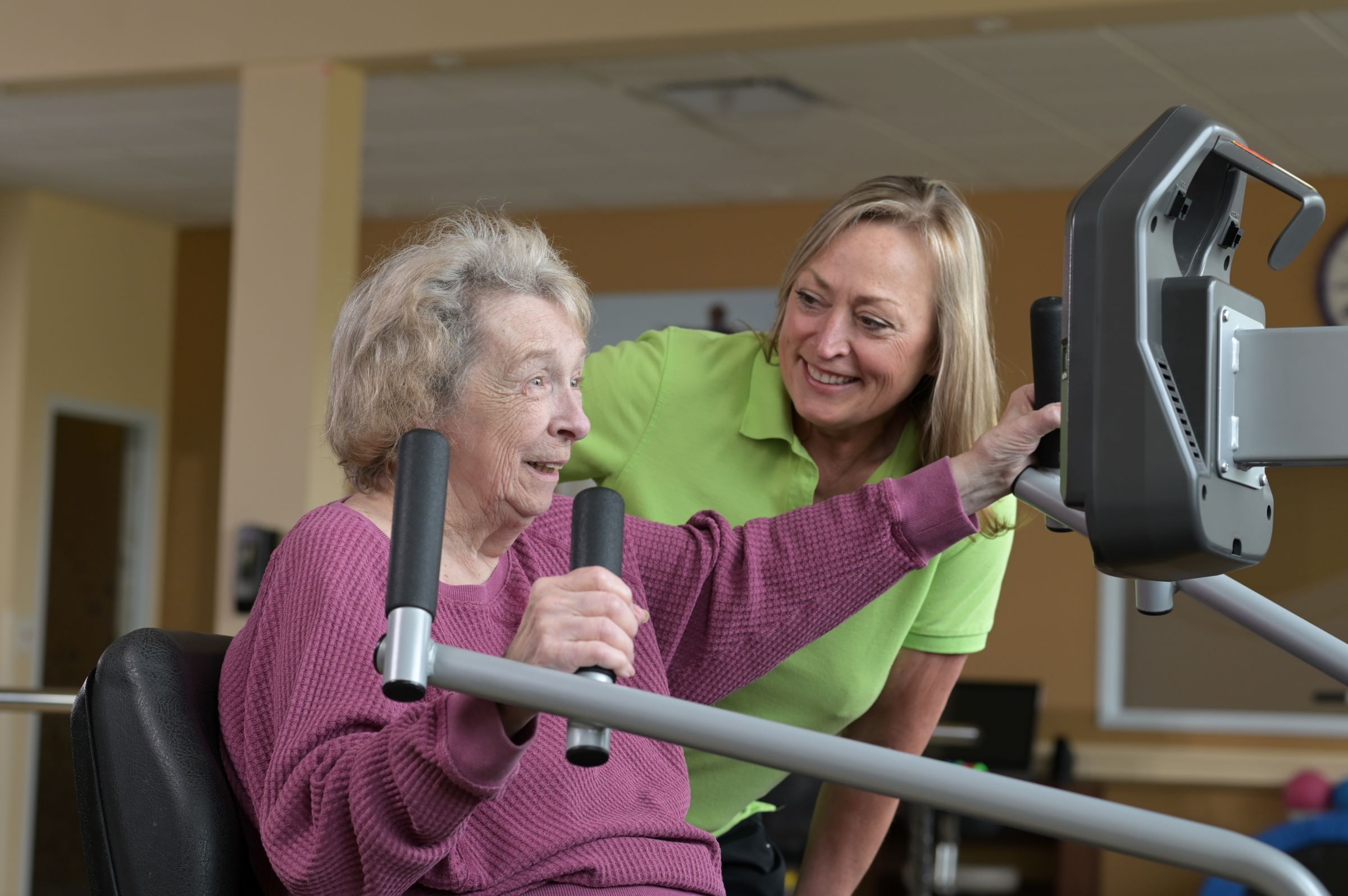 senior with physical therapist using the NuStep