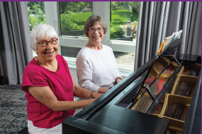 two ladies playing piano at Glacier Hills
